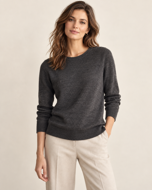 Woman wearing Maison Aria classic crewneck sweater in charcoal